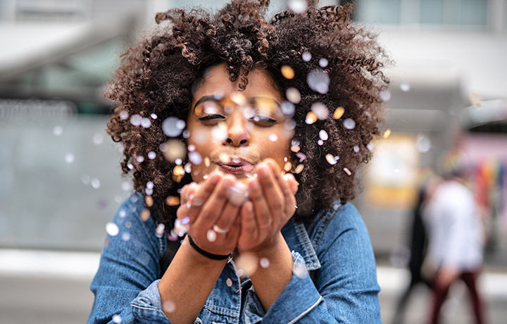 Woman blowing confetti