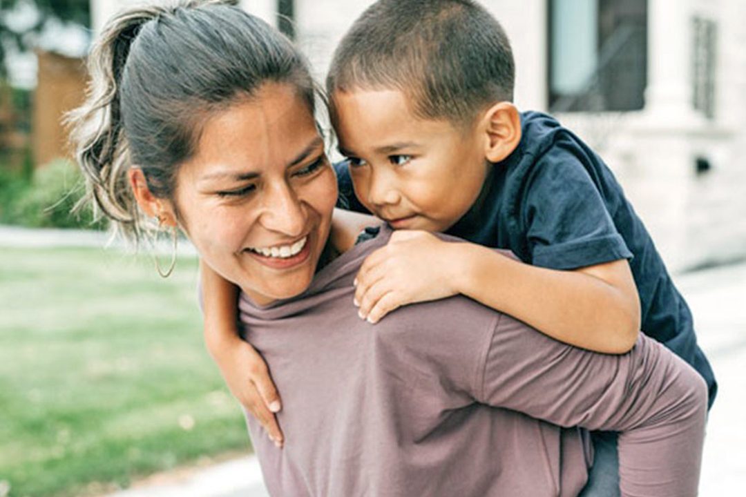 child on woman's back