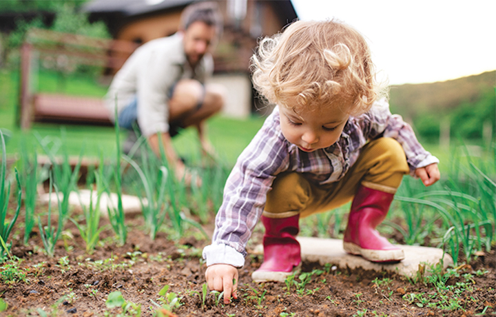 toddler playing in mud