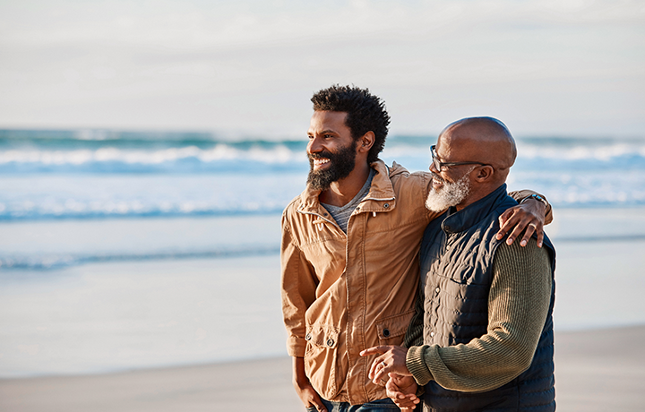 two men walking on the beach